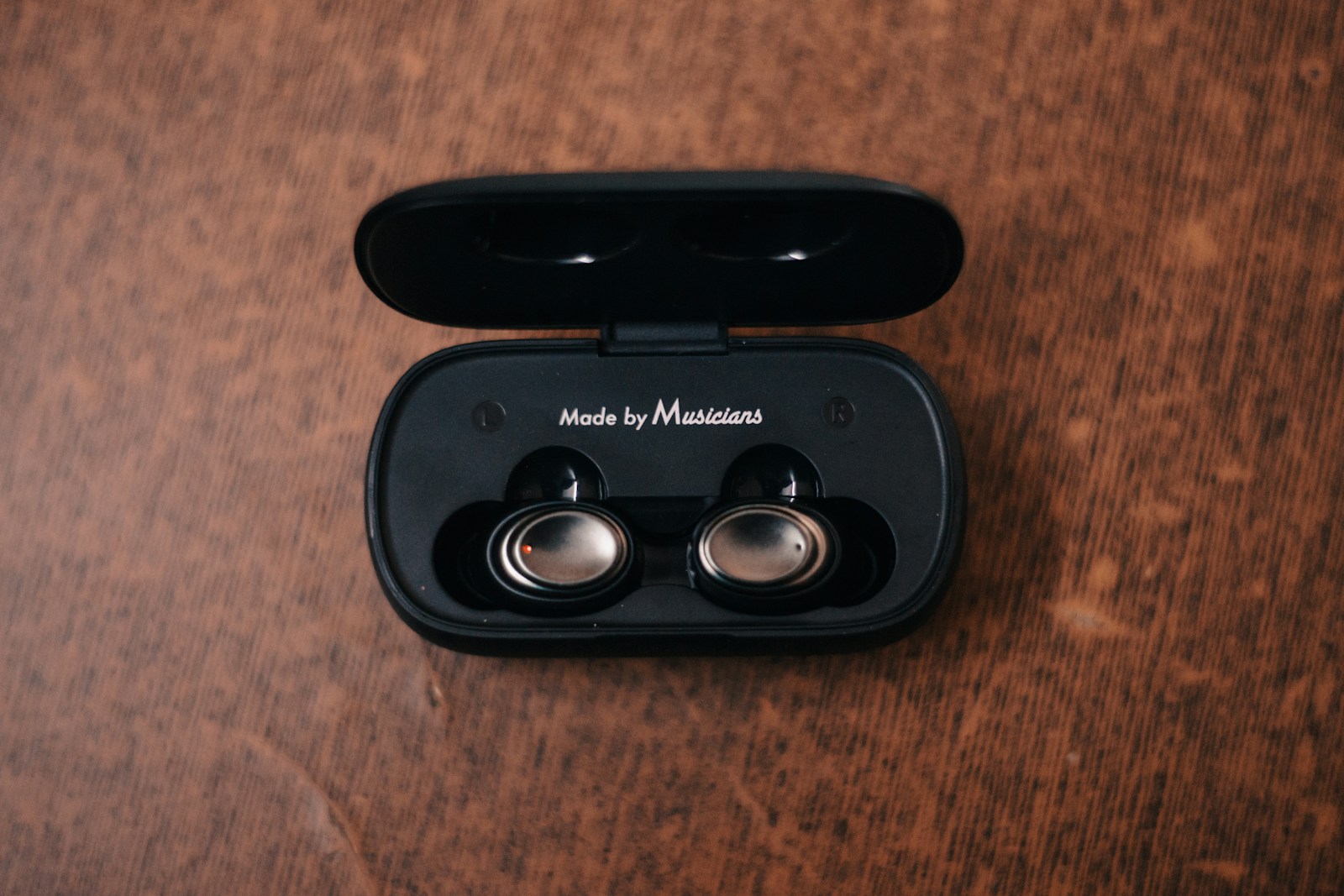 a pair of headphones sitting on top of a wooden table